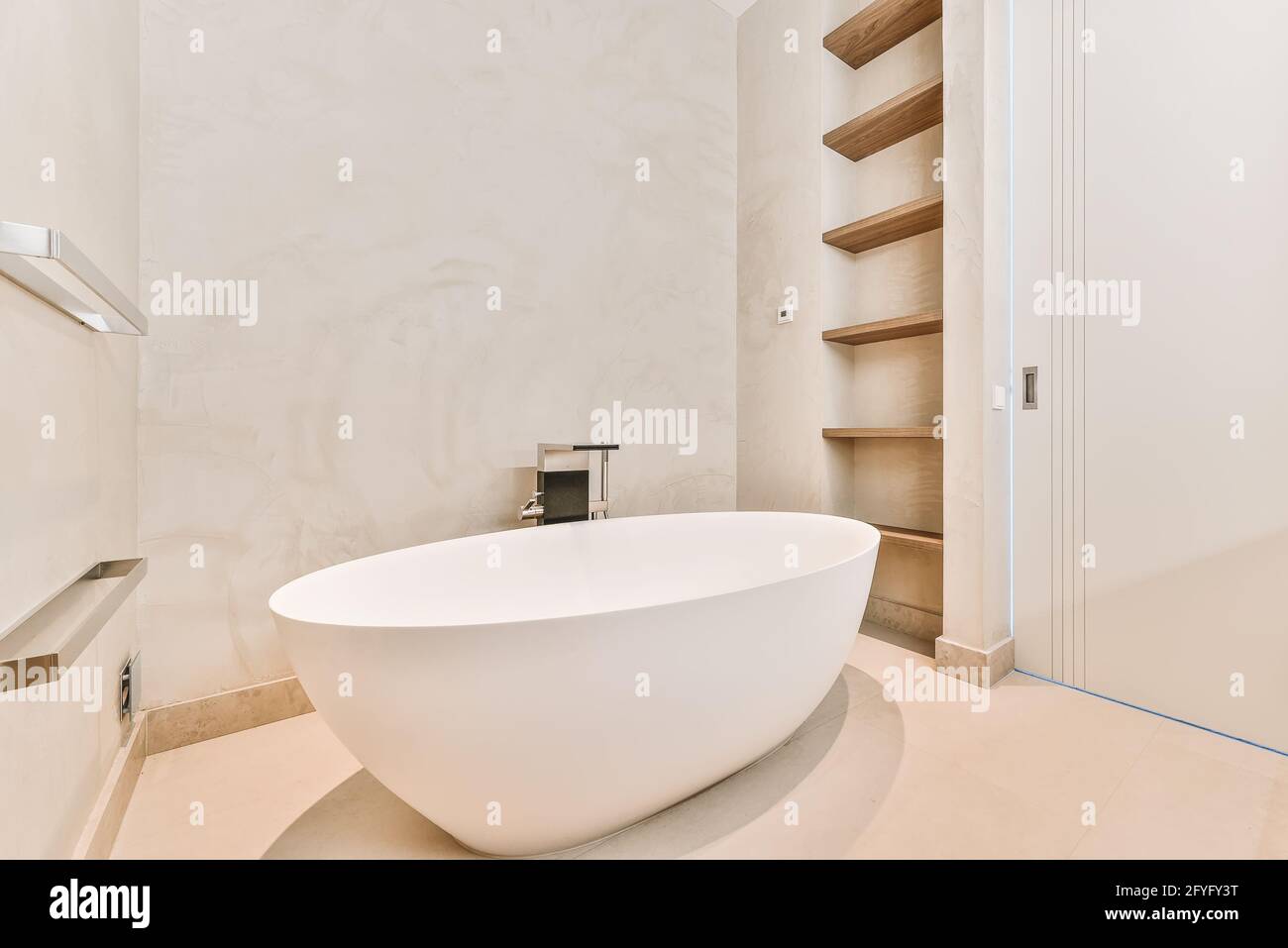 Minimalist bathroom interior design with big soaking tub in center and