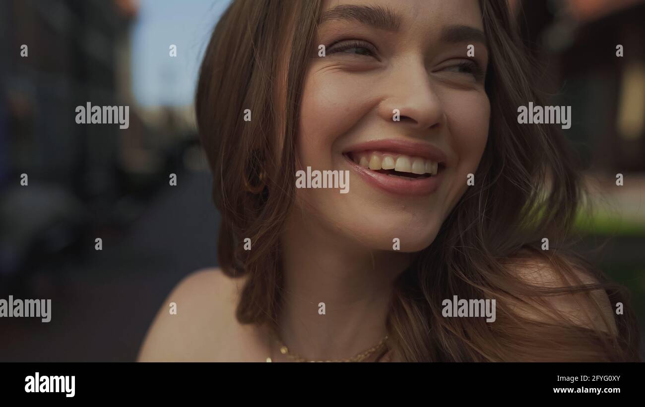 close up of happy young woman smiling outside Stock Photo