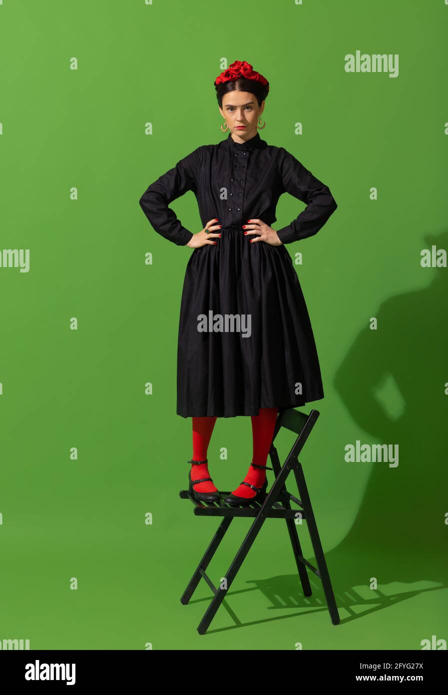 Young beautiful woman in image of famous painter, artist Frida Kahlo on  green background Stock Photo - Alamy