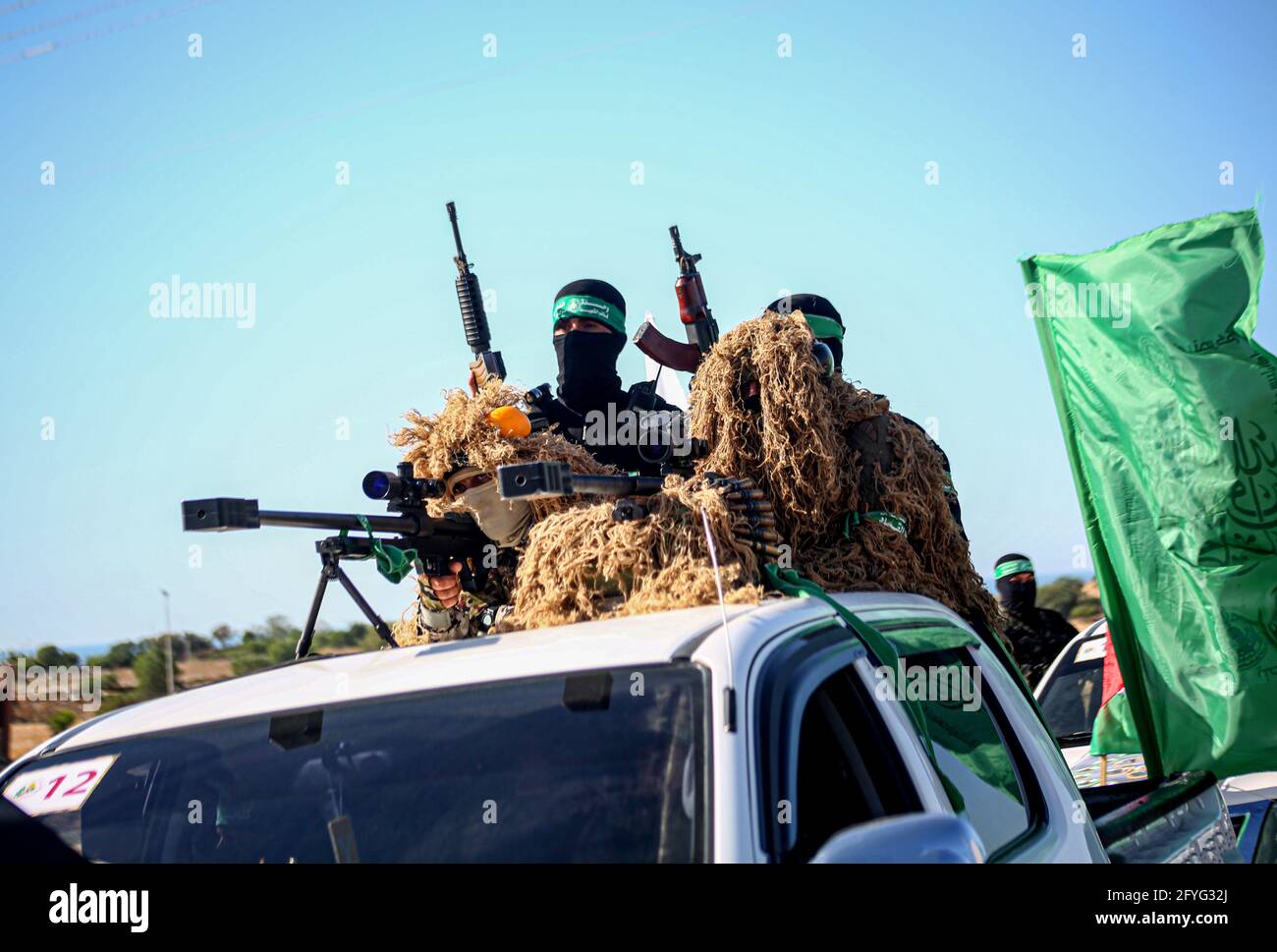 Gaza, Palestine. 27th May, 2021. Masked members of the Izz al-Din al-Qassam Brigades, the military wing of Hamas drive in cars while carrying heavy weapons during a military parade on the Streets in Khan Yunis, southern Gaza Strip. (Photo by Yousef Masoud/SOPA Images/Sipa USA) Credit: Sipa USA/Alamy Live News Stock Photo