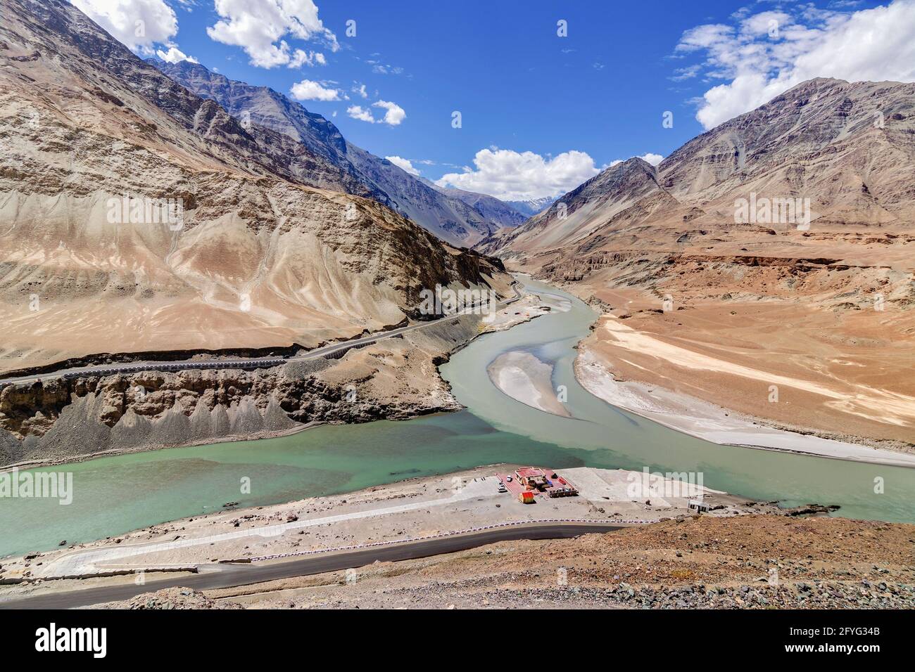 Scenic view of Confluence of Zanskar river from left and Indus rivers from up right - Leh, Ladakh, Jammu and Kashmir, India. Famous tourist spot. Stock Photo