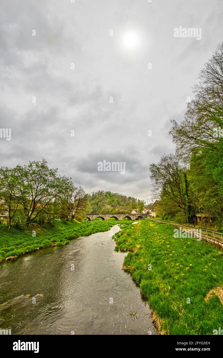 Old Stone Bridge in cloudy weather, in Kirchber at the Jagst River, Baden-Wuerttemberg, Soutgh Germany Stock Photo
