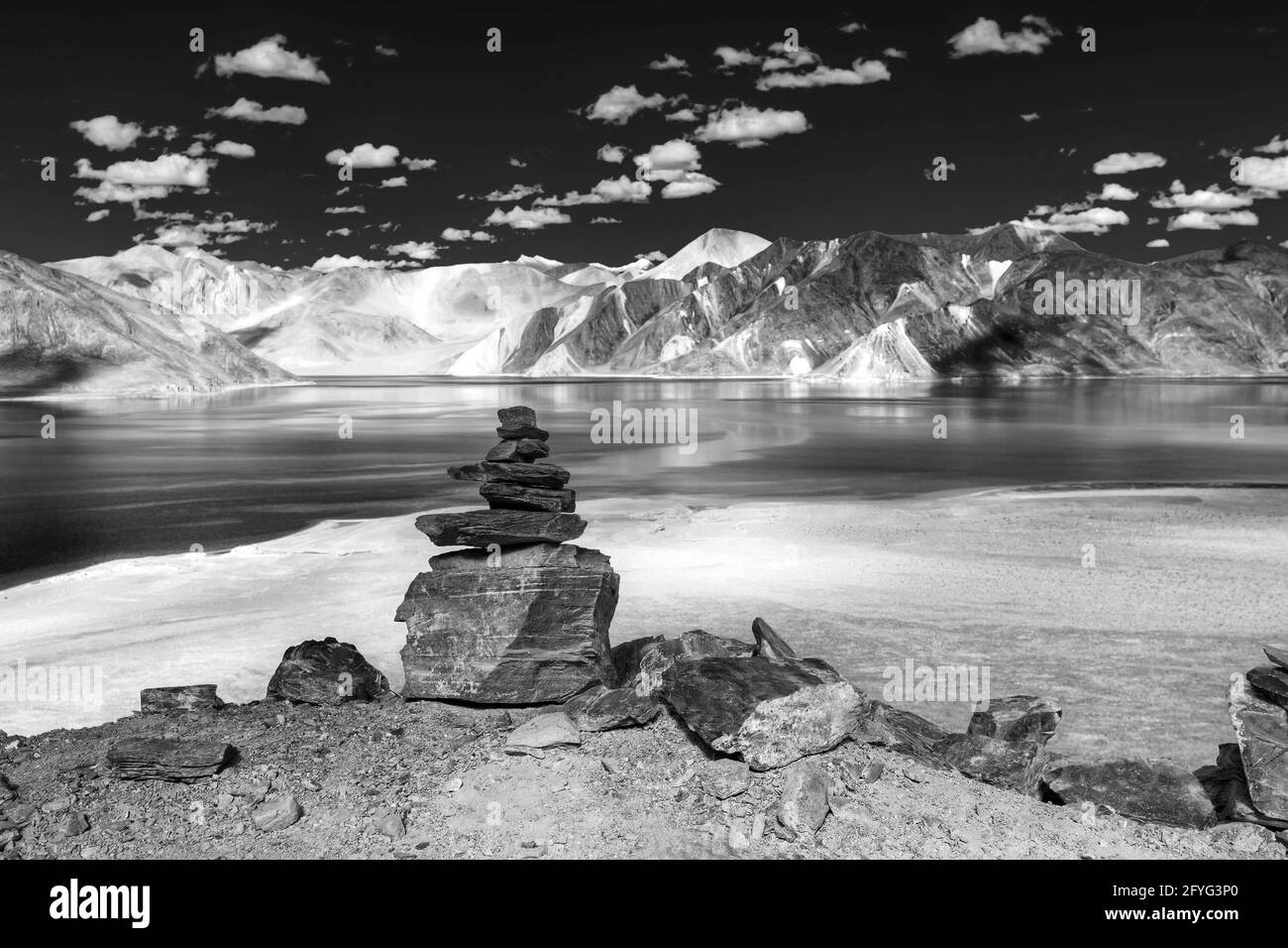 Rocks and reflection of Mountains on Pangong tso (Lake). It is huge lake in Ladakh, India. India China border. Stock Photo