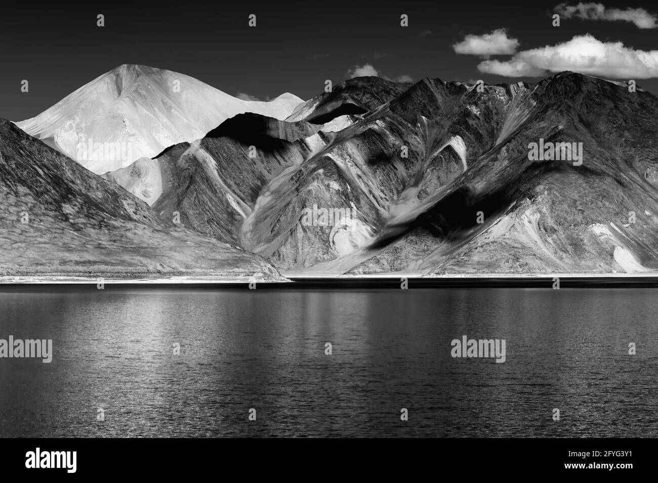 Reflection of Mountains on Pangong tso - Lake It is huge lake in Ladakh, It is 134 km long and extends from India to Tibet. Leh, Ladakh. Indian border. Stock Photo