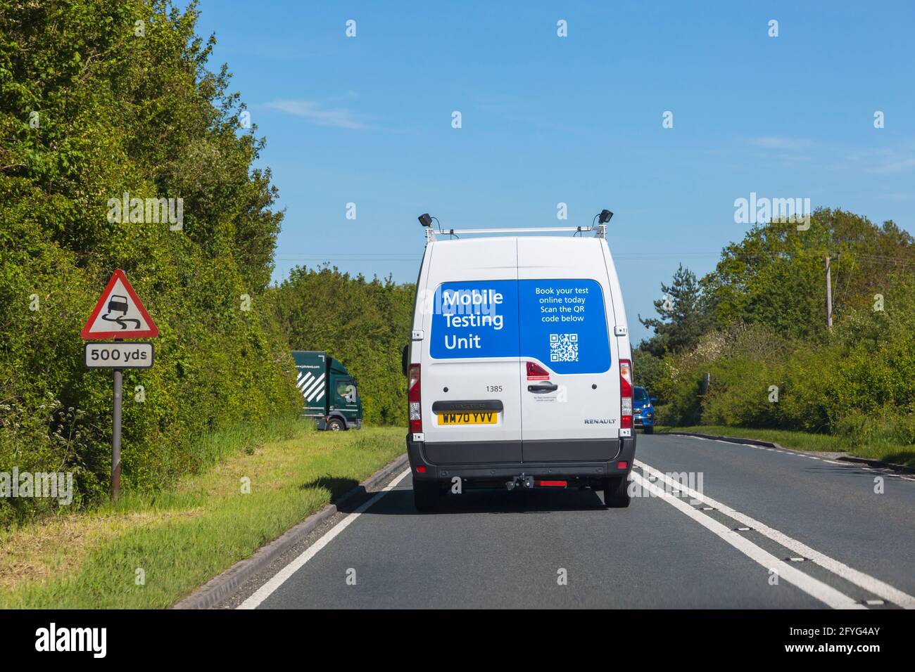 Mobile Testing Unit Renault Master van driving along road in Dorset UK in May - mobile covid testing Stock Photo
