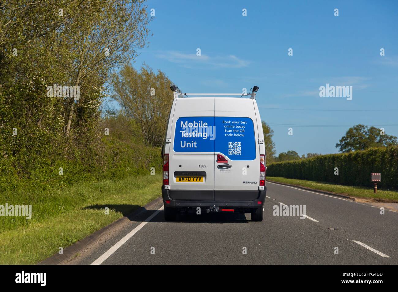 Mobile Testing Unit Renault Master van driving along road in Dorset UK in May - mobile covid testing Stock Photo