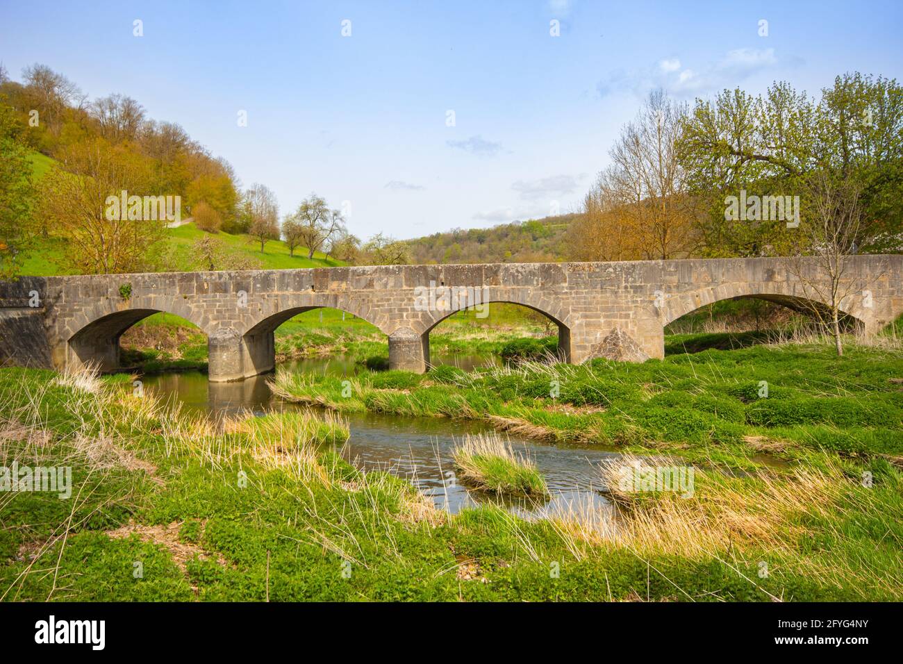 Stone bridge at Tauberscheckenbach in spring, on the Tauber River, Bavaria, South Germany Stock Photo
