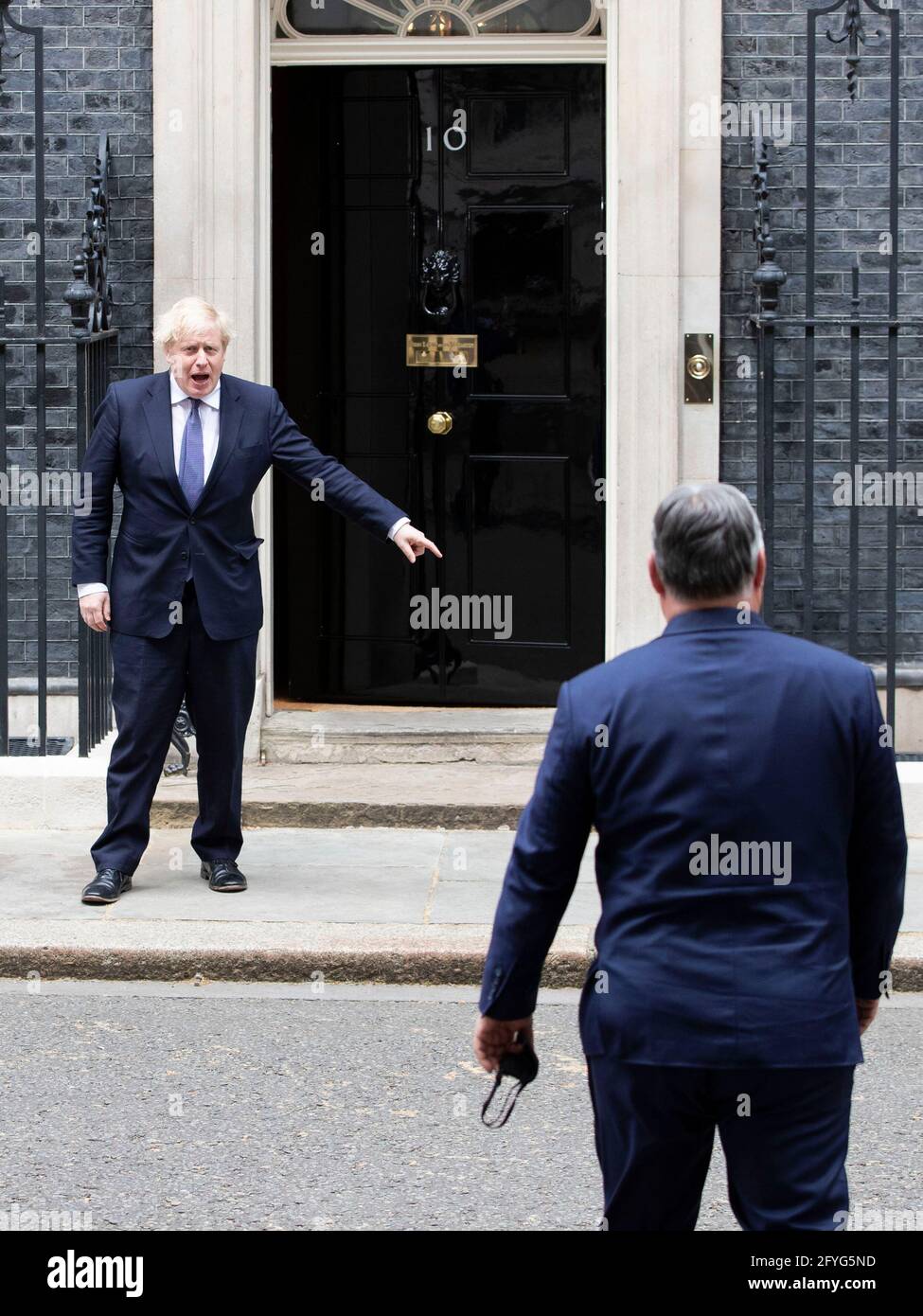 UK Prime Minister Boris Johnson welcomes Hungarian PM Viktor Mihály Orbán to 10 Downing Street on the 28th of May 2021, as he is questioned  by press. Stock Photo