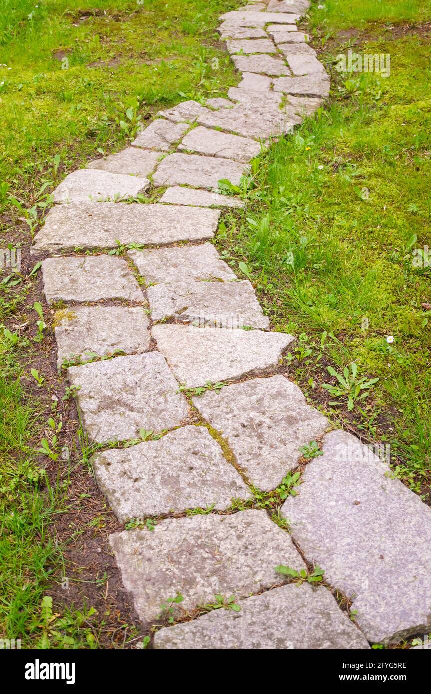Path through lawn paved with stone tiles Stock Photo Alamy