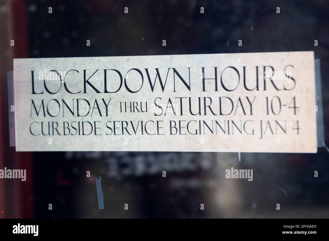 Lockdown hours for a store in Kingston, Ontario on Friday, January 8, 2021, as the COVID-19 pandemic continues across Canada and around the world. Stock Photo