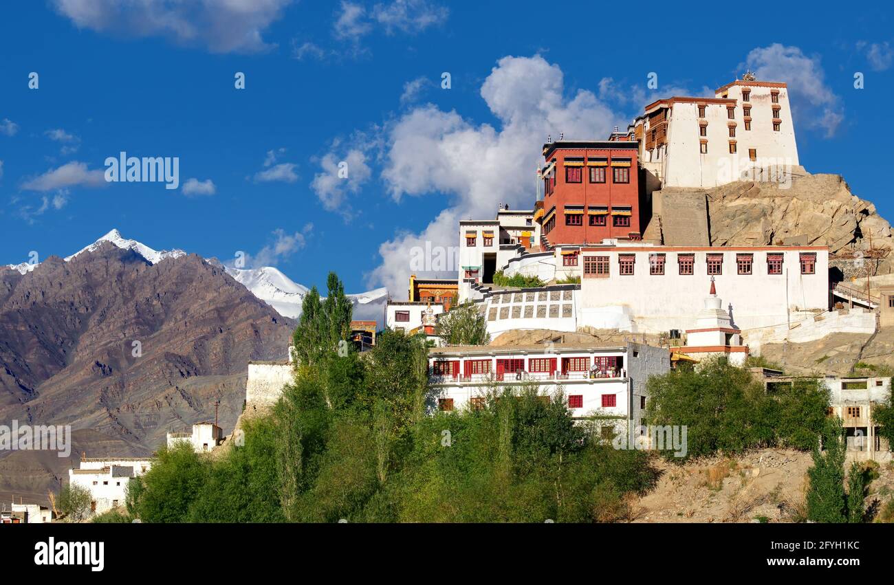 Thiksay monastery with view of Himalayan mountians and blue sky with white clouds in background,Ladakh,Jammu and Kashmir, India Stock Photo