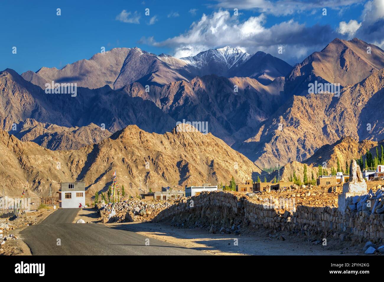 Highway of Leh with rocky mountains and snow peak with blue sky in background, Leh, Ladakh, Jammu and Kashmir, India Stock Photo
