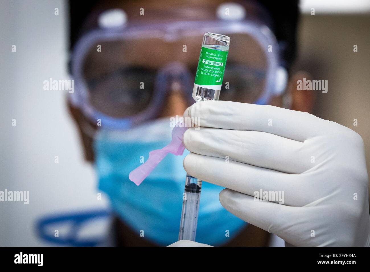 The AstraZeneca COVID-19 vaccine is being withdrawn with a syringe before use at a pharmacy in Kingston, Ontario on Thursday, March 18, 2021, as the C Stock Photo