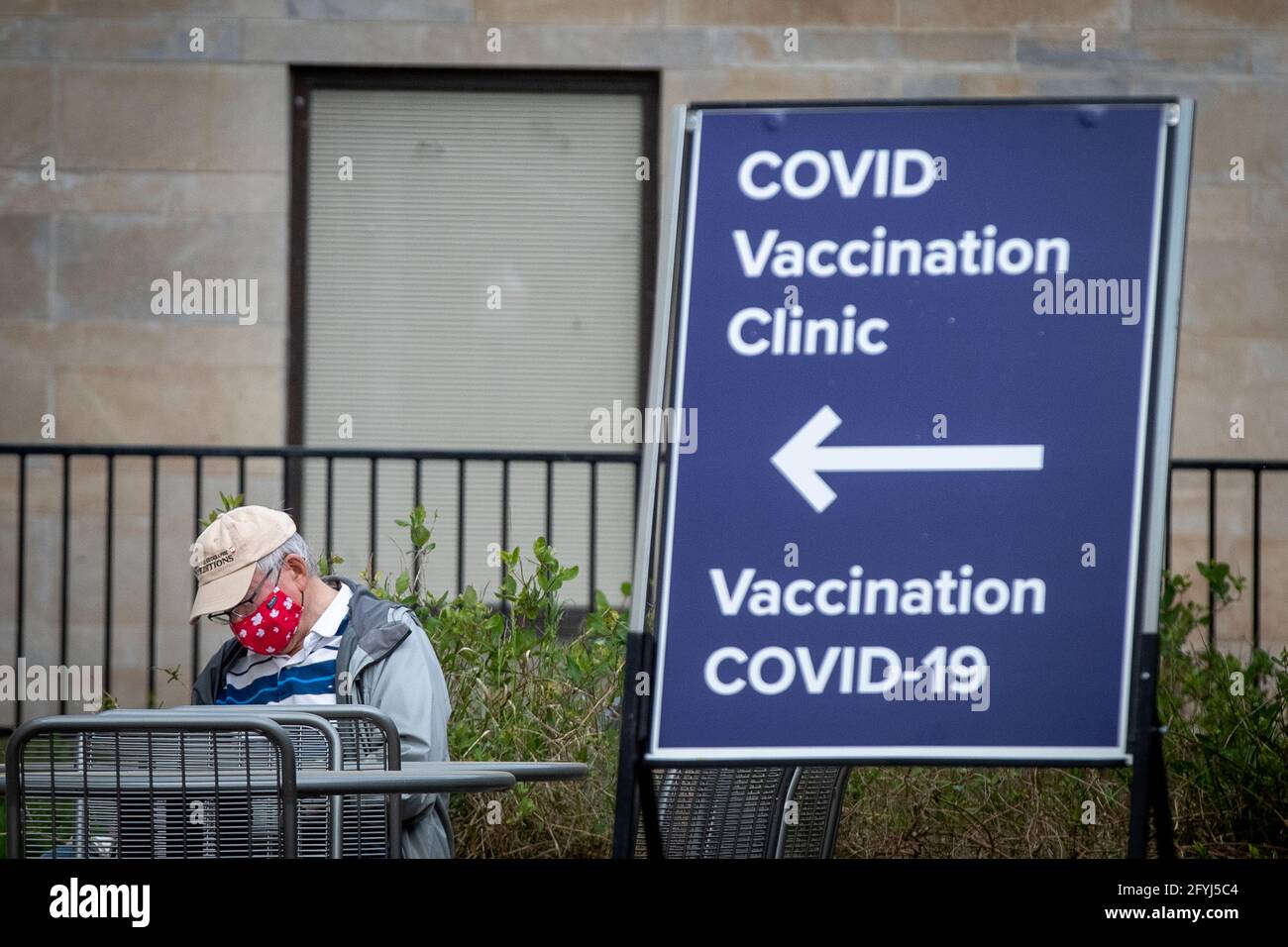 A person wears a mask with maple leaves outside a COVID-19 vaccine clinic at Kingston general hospital (KGH) in Kingston, Ontario on Thursday May 20, Stock Photo