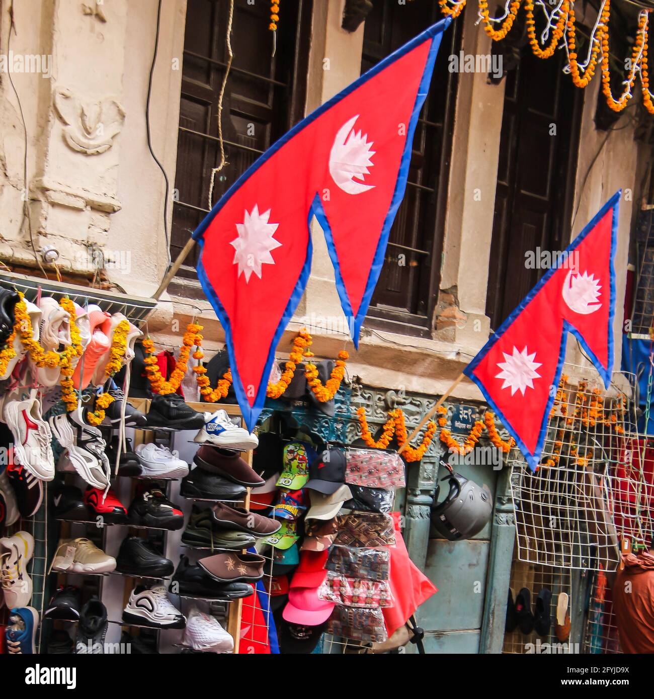 Nepali flags hang outside a shoe shop in Kathmandu, Nepal Stock Photo