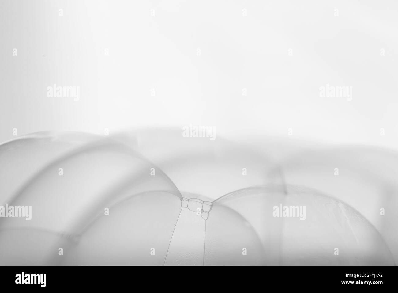 Many soap bubbles piled on white background in details Stock Photo