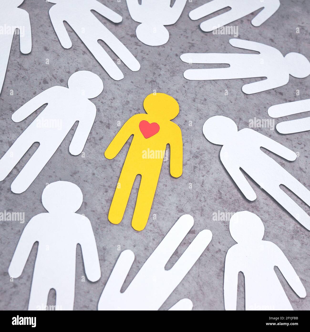 Paper cut Figures In Center Is Yellow Man With Red Heart In Chest 