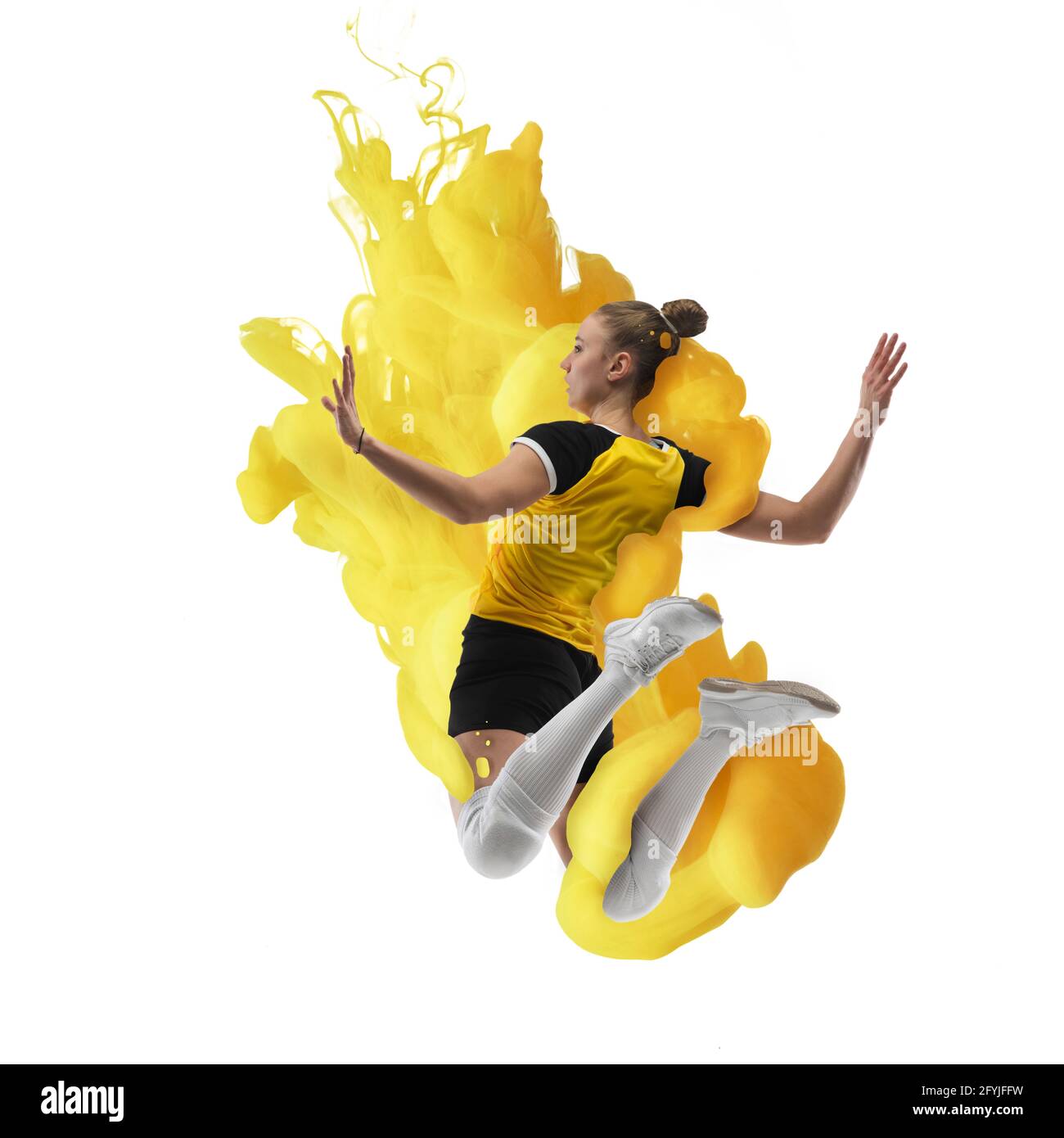 Exploding Volleball Young girl volleyball player in explosion of yellow colored neon ...