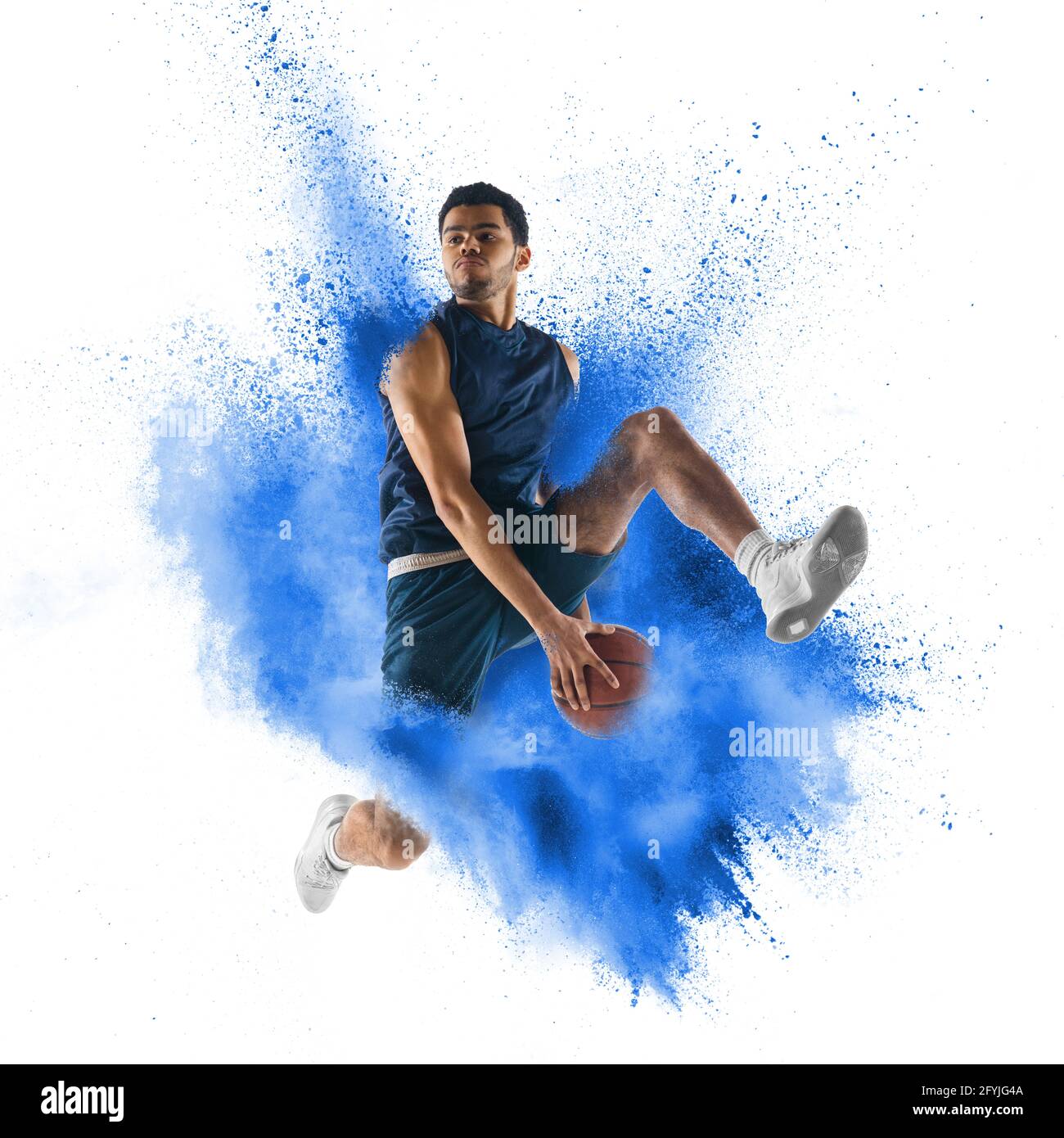 One young sportsman basketball player in explosion of colored neon