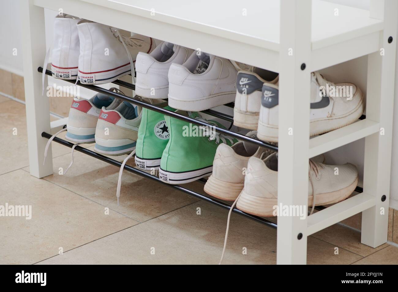 private shoe shelf of a family with sports shoes Stock Photo