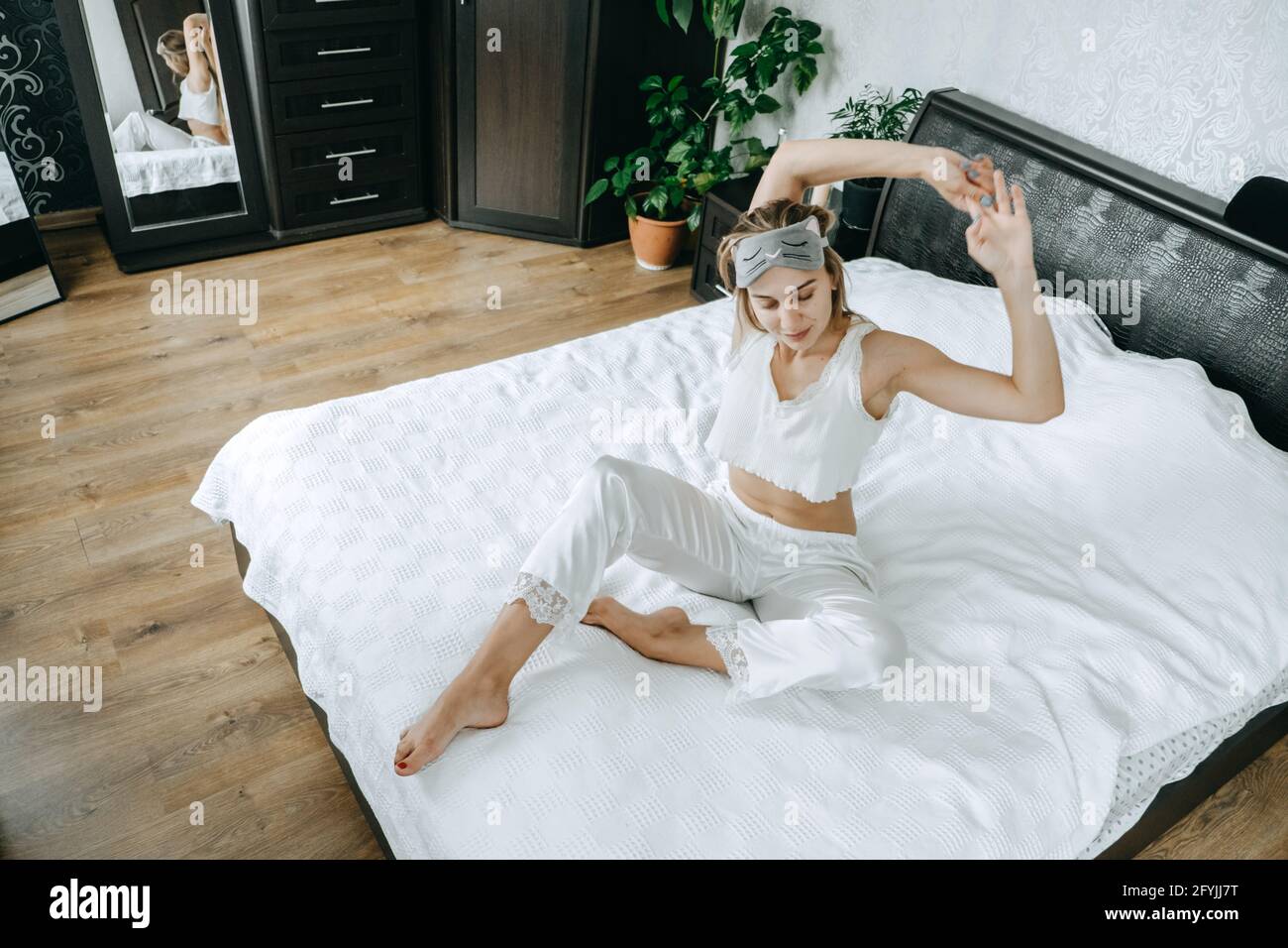 Self care, Mental health, mental wellbeing, calm, mourning routines, start day. No stress, healthy habit, concept. Young woman in pajamas doing Stock Photo