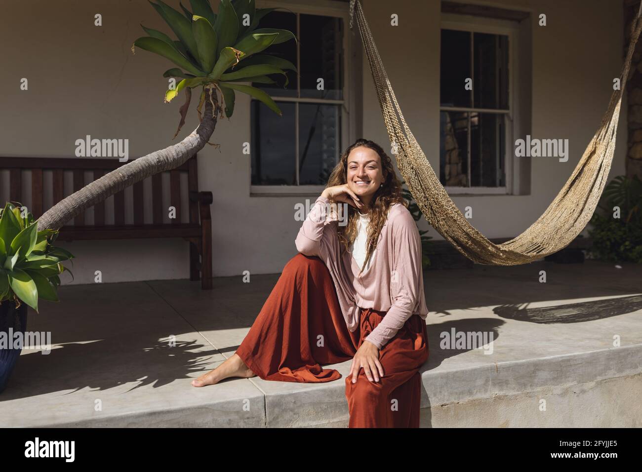 Young woman sitting on terrace hi-res stock photography and images - Alamy