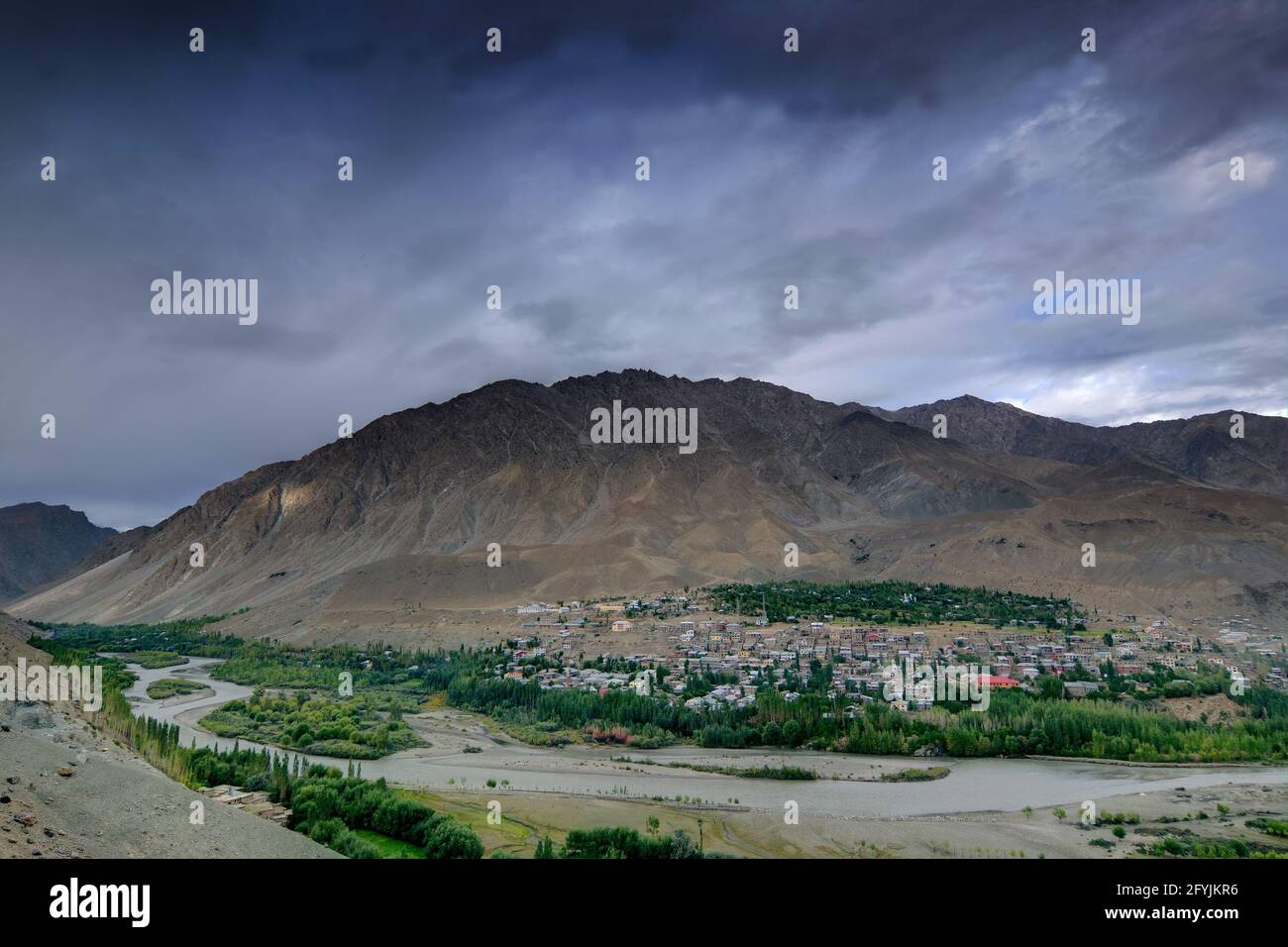 Top view of Indus river and Kargil City valley with Himalayan mountains and blue cloudy sky in background, Leh, Ladakh, Jammu and Kashmir, India Stock Photo