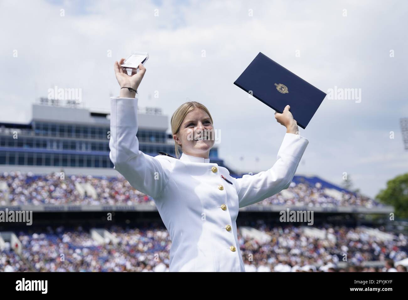 An Unidentified Graduate Of The United States Naval Academy Celebrates After Receiving Her