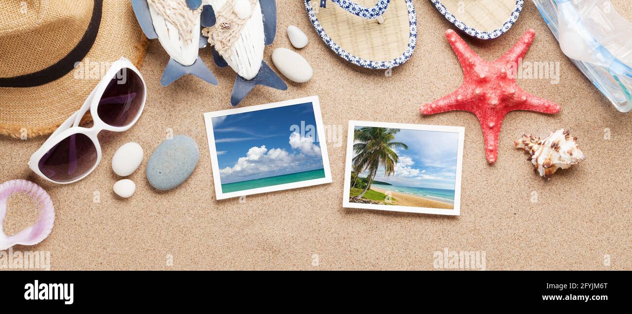 Travel vacation background concept with sunglasses, beach hat, seashells and photos on sand backdrop. Top view flat lay Stock Photo