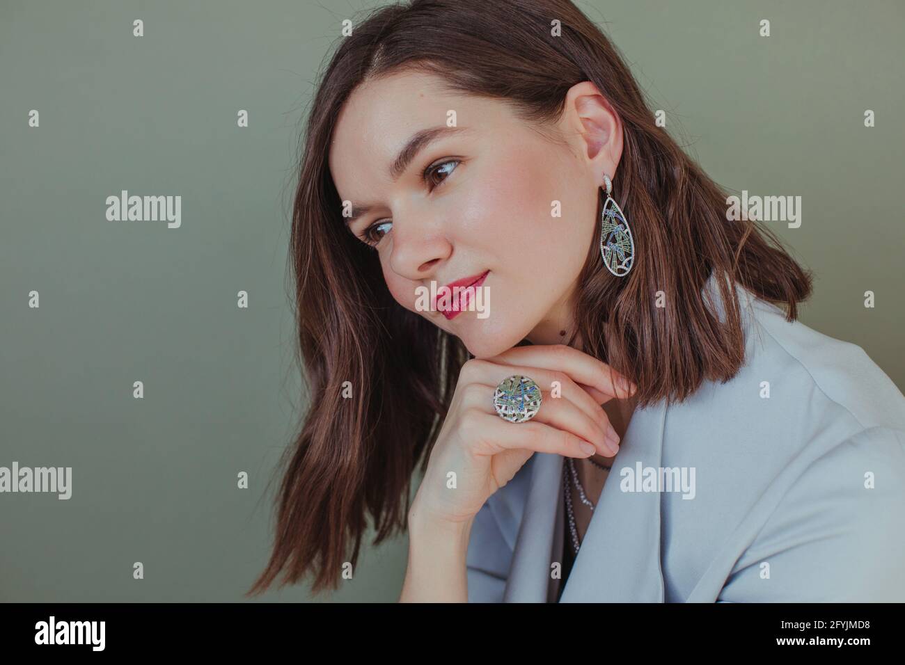 Portrait of a beautiful woman resting her chin on her hand Stock Photo