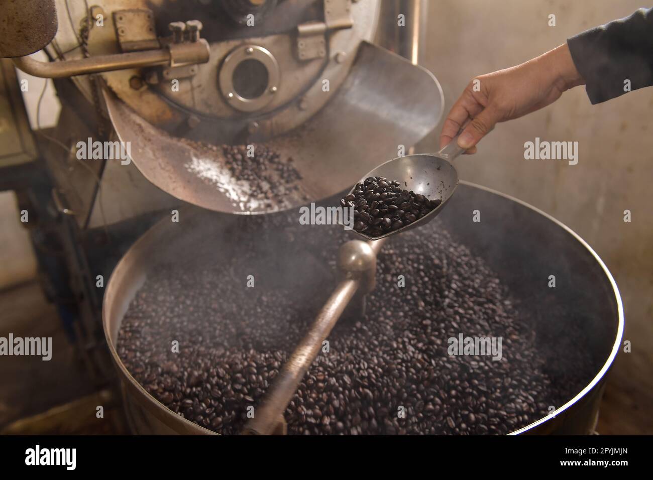 Close-up of a woman roasting coffee beans Stock Photo