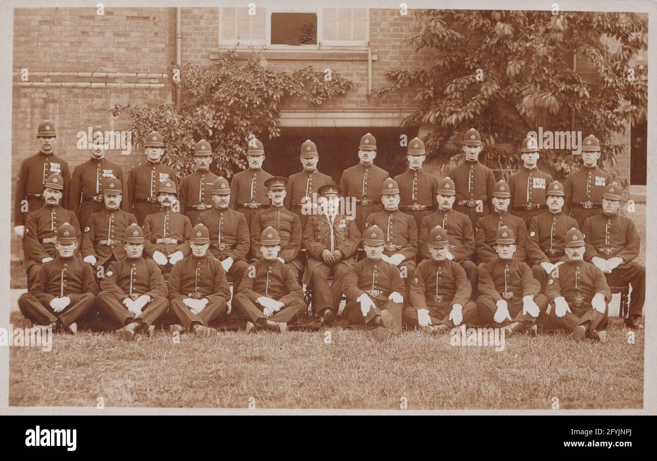 Vintage early 20th century photographic postcard showing a large group of British Police Officers. Stock Photo
