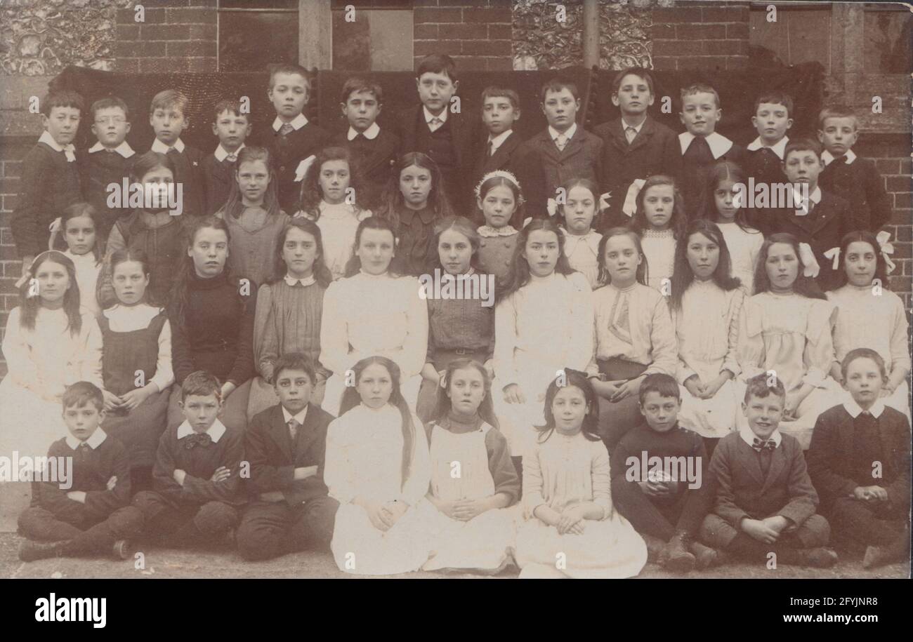 Vintage early 20th century photographic postcard showing a large group of British school children. Stock Photo