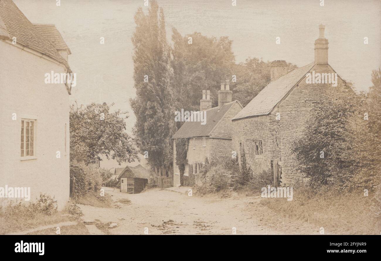 Vintage Edwardian photographic postcard of a picturesque British rural village. Stock Photo