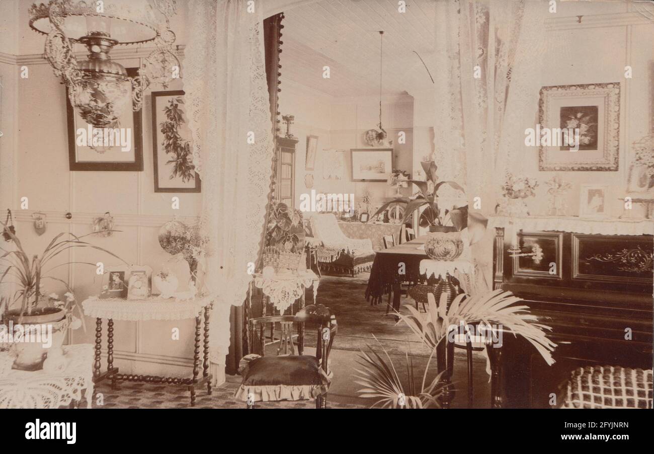 Vintage early 20th century photographic postcard showing the interior rooms of a grand house. Stock Photo
