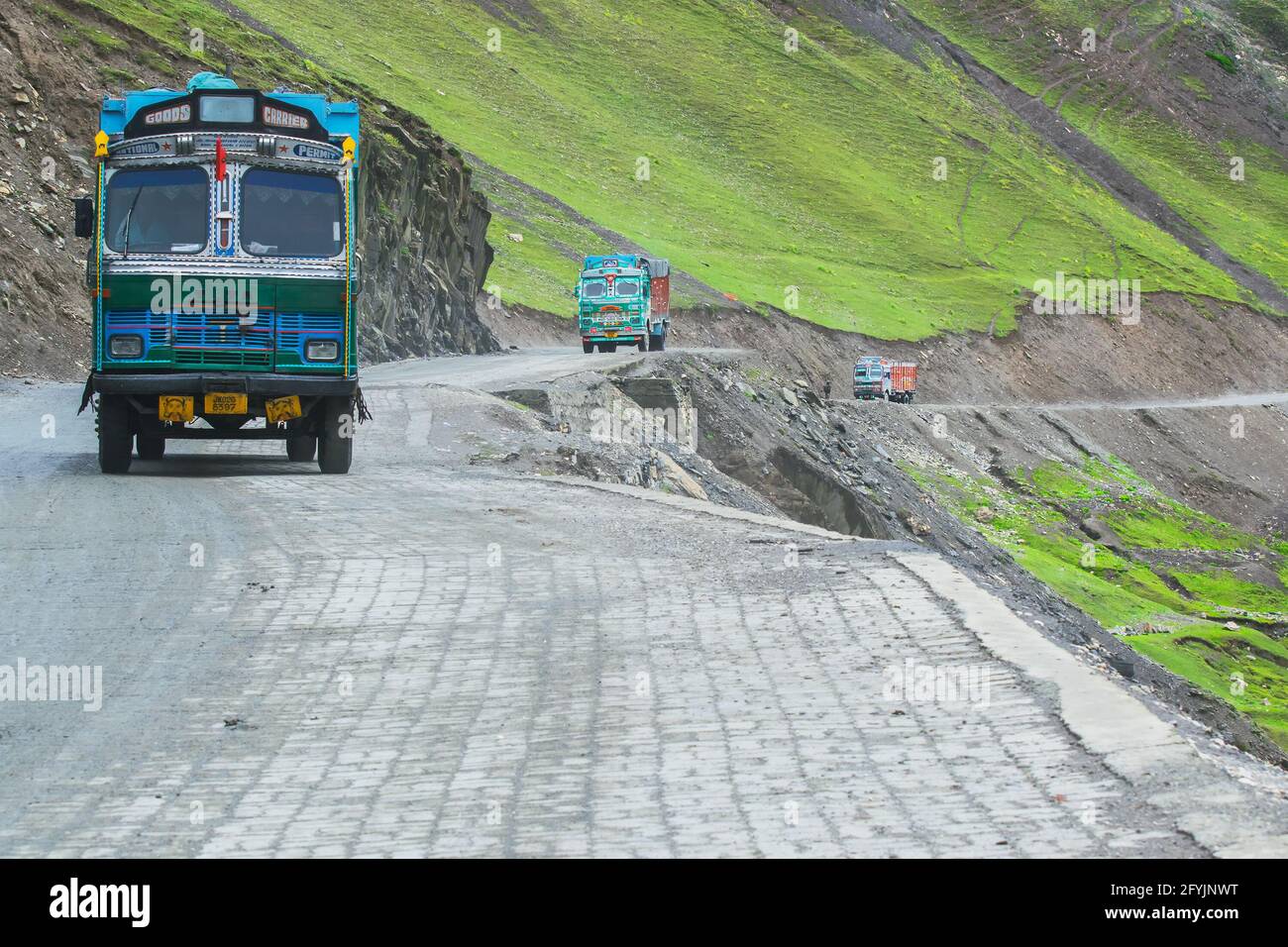 LEH, INDIA - SEPTEMBER 1, 2014 : Trucks carrying goods are passing through Zojila Pass, a high mountain pass between Srinagar and Leh at 11575 ft. Stock Photo
