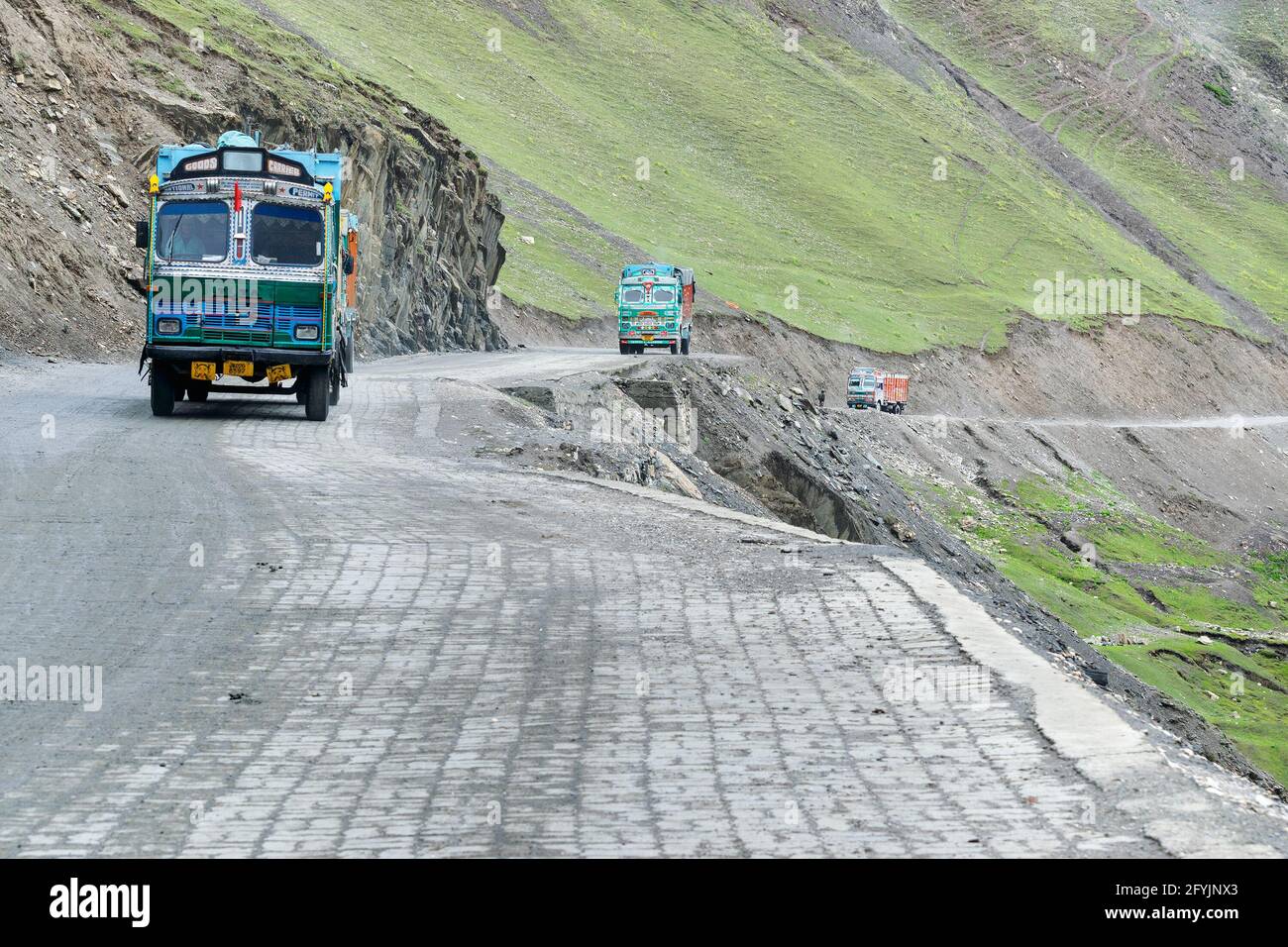 LEH, INDIA - SEPTEMBER 1, 2014 : Trucks carrying goods are passing through Zojila Pass, a high mountain pass between Srinagar and Leh at 11575 ft. Stock Photo