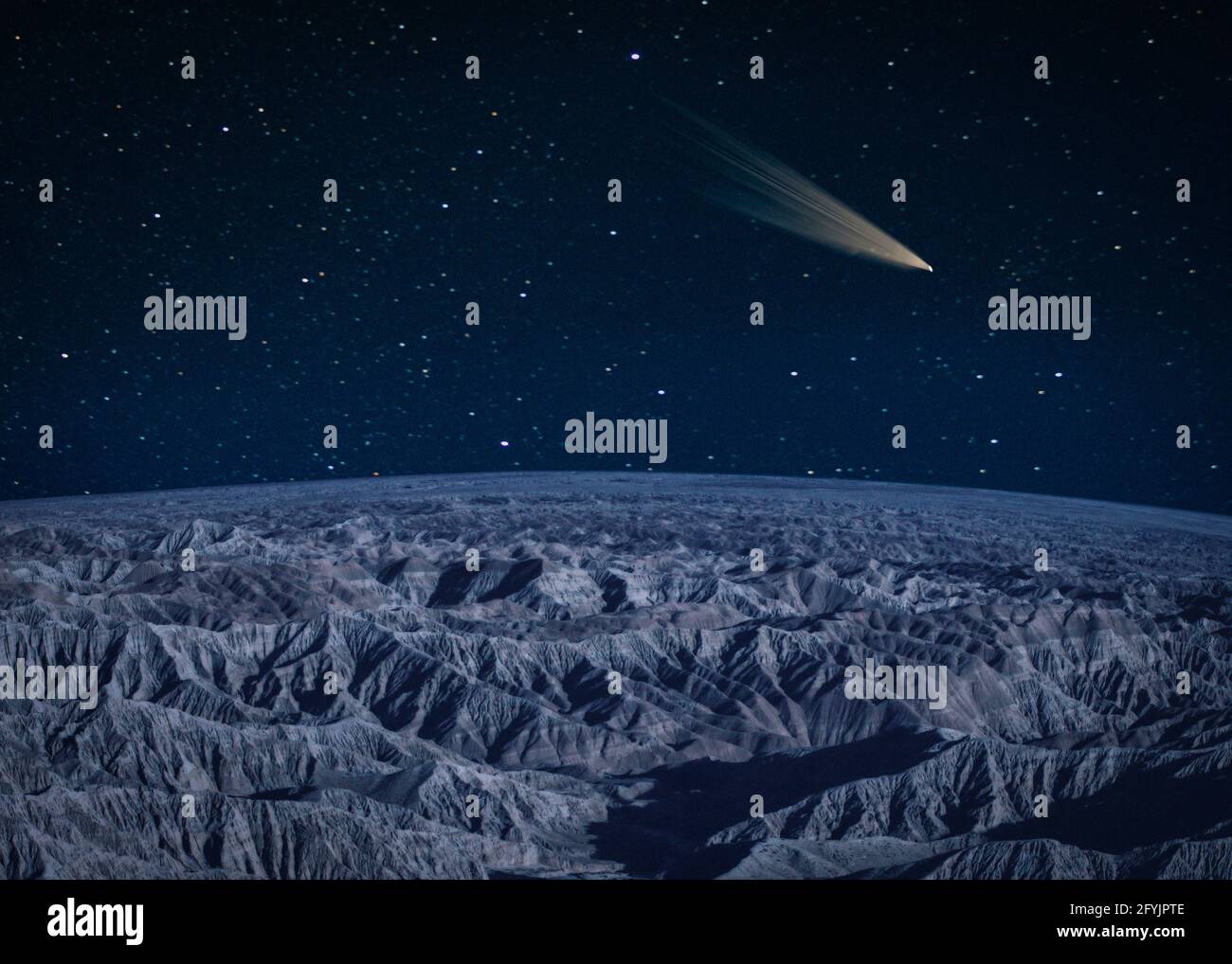 Comet passing over a barren mountain landscape Stock Photo