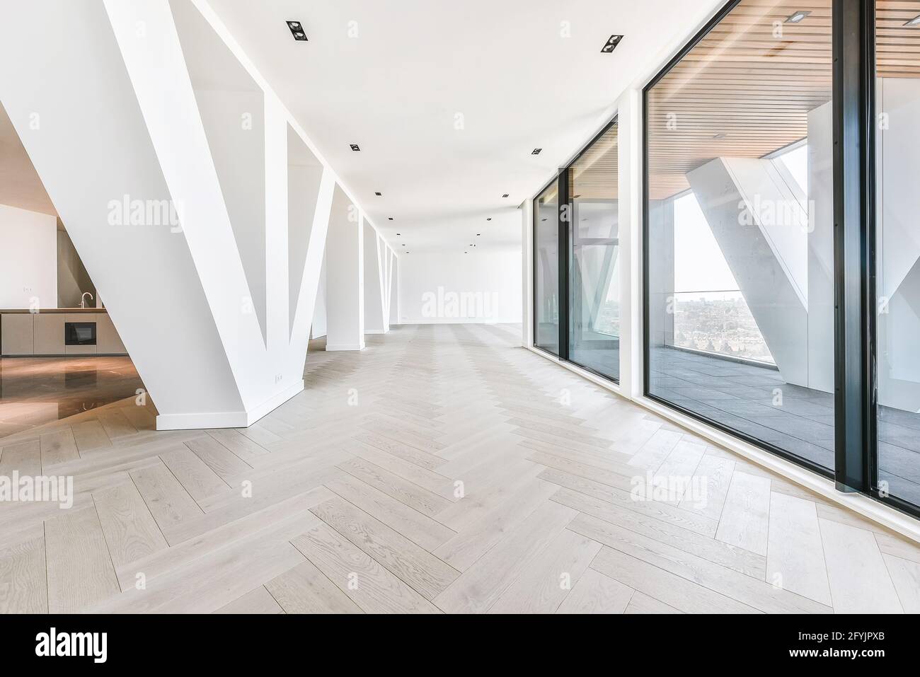 Penthouse interior of studio room with glass walls and terrace viewing ...