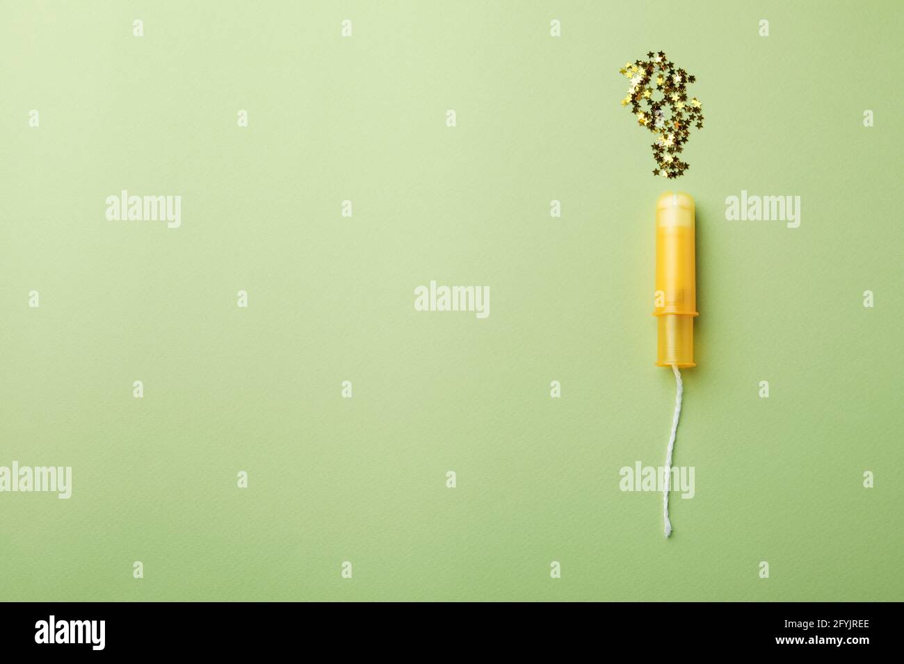 Fresh tampon and glitter on green background Stock Photo Alamy