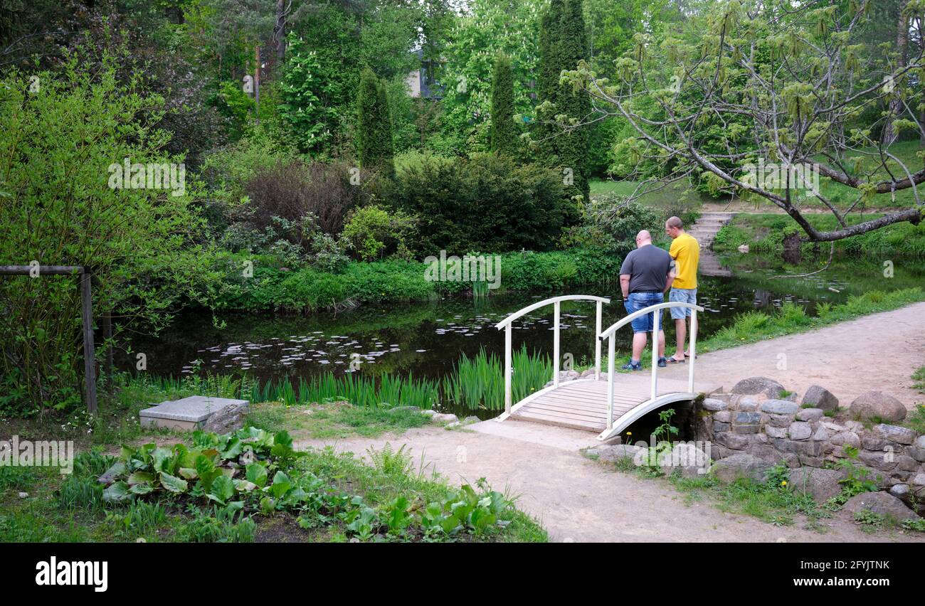Two men at pond in Pakrovska Nature Park in Ogre Latvia Stock Photo