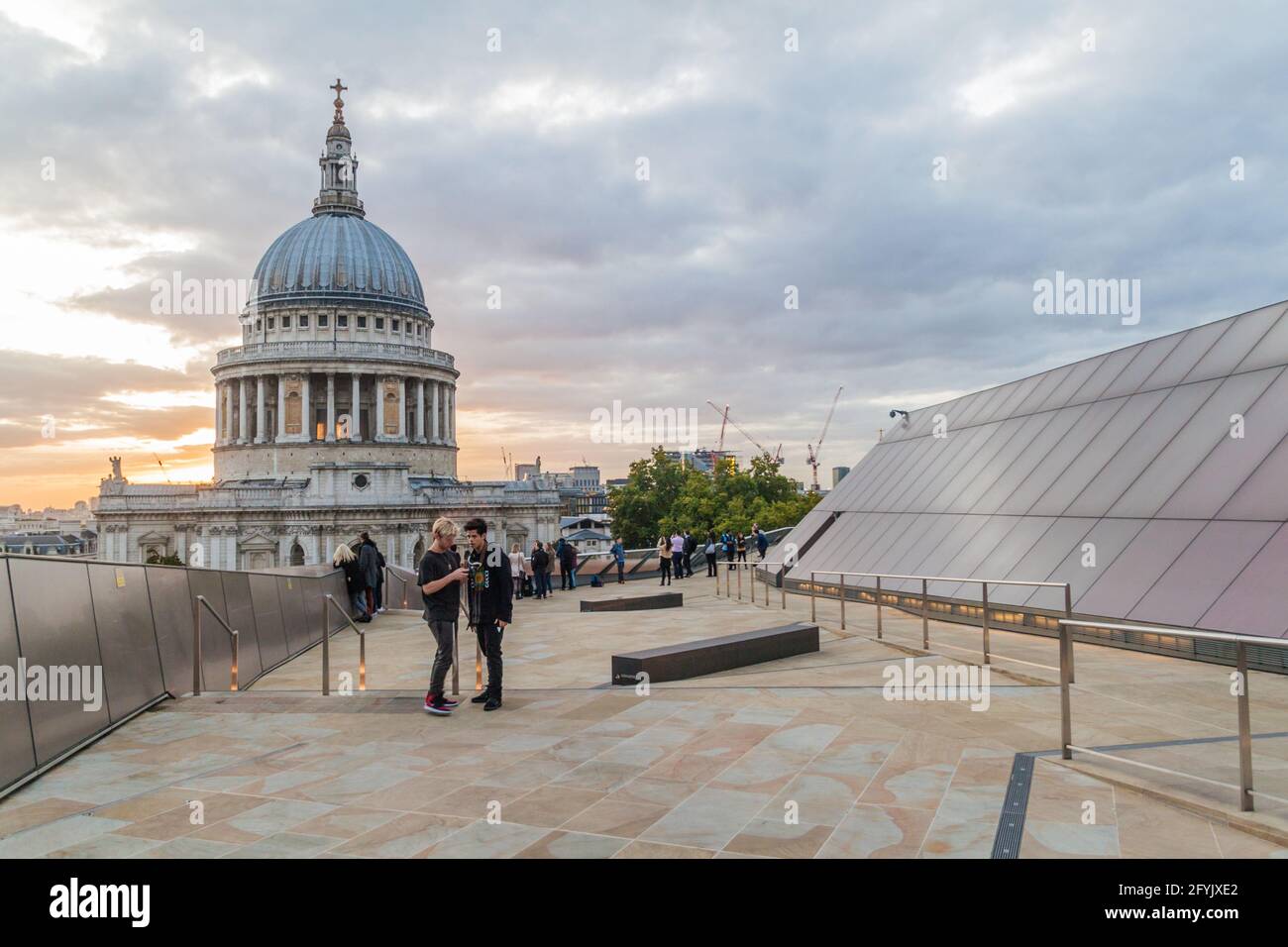 LONDON, UNITED KINGDOM - OCTOBER 4, 2017: People at the observation deck of One New Change Rooftop in London look at the cupola of St. Paul's Cathedra Stock Photo
