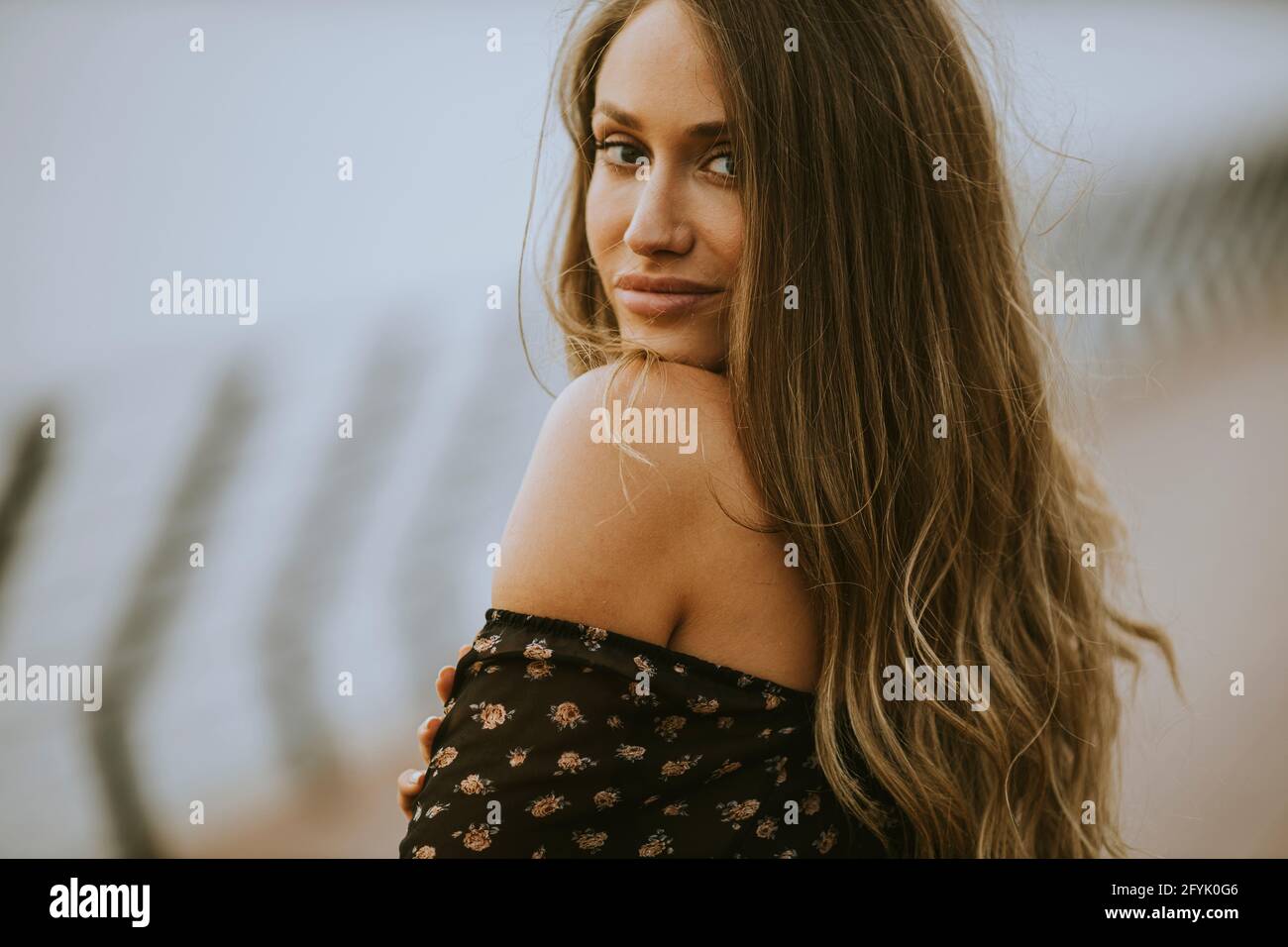 Pretty young long hair brunette woman walking on the riverside Stock ...