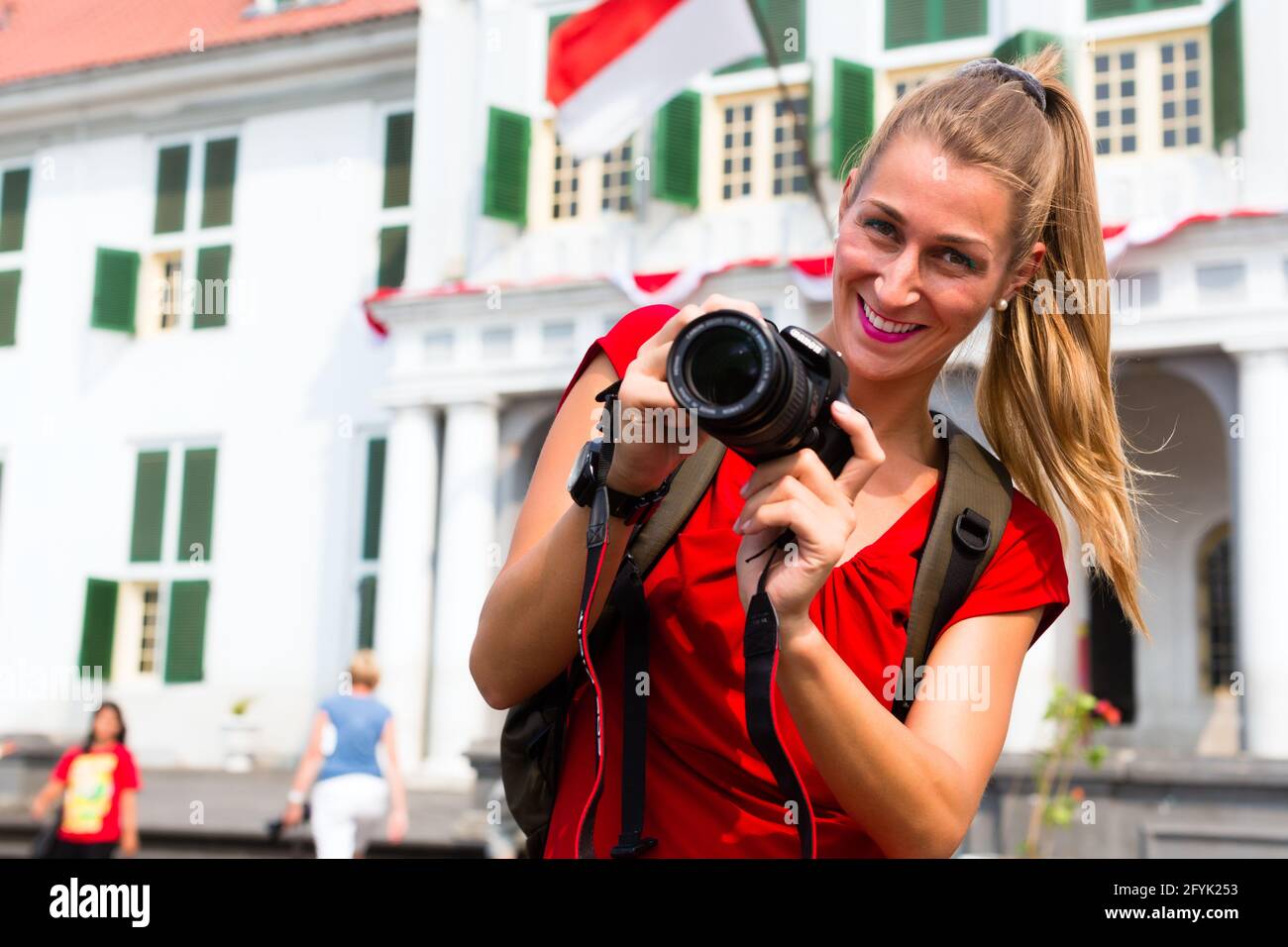 Woman tourist taking pictures in old Batavia colonial district of