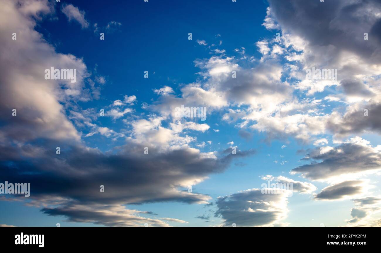 Cloudy heaven concept. Fluffy white and grey clouds on blue sky background, space. Overcast horizon, abstract, windy atmosphere, idyllic environment, Stock Photo