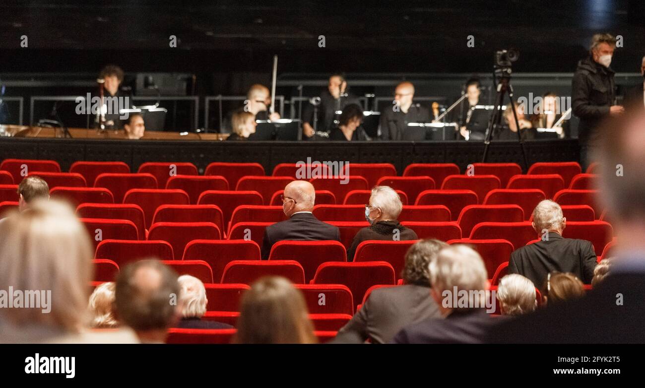Hamburg, Germany. 28th May, 2021. Visitors sit far apart from each other in the Hamburg State Opera. After the Corona break, the opera reopens with the opera Agrippina. However, due to the Corona protective measures, the number of spectators and the safety distances in the auditorium are reduced. Credit: Markus Scholz/dpa/Alamy Live News Stock Photo