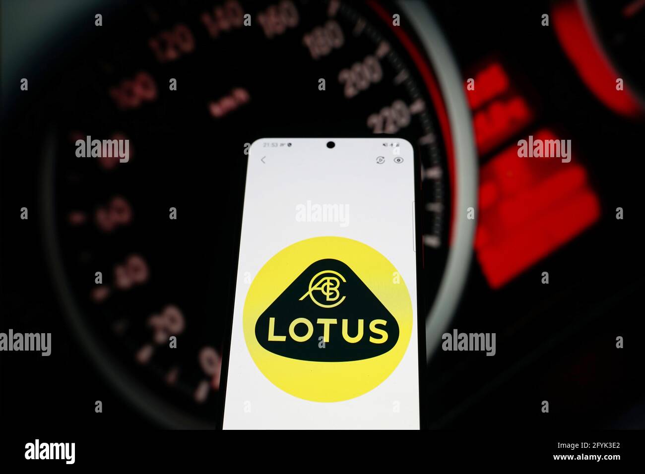 China. 28th May, 2021. In this photo illustration a car brand logo 'Lotus' seen displayed on a smartphone with car dashboard in the background. (Photo by Alvin Chan/SOPA Images/Sipa USA) Credit: Sipa USA/Alamy Live News Stock Photo