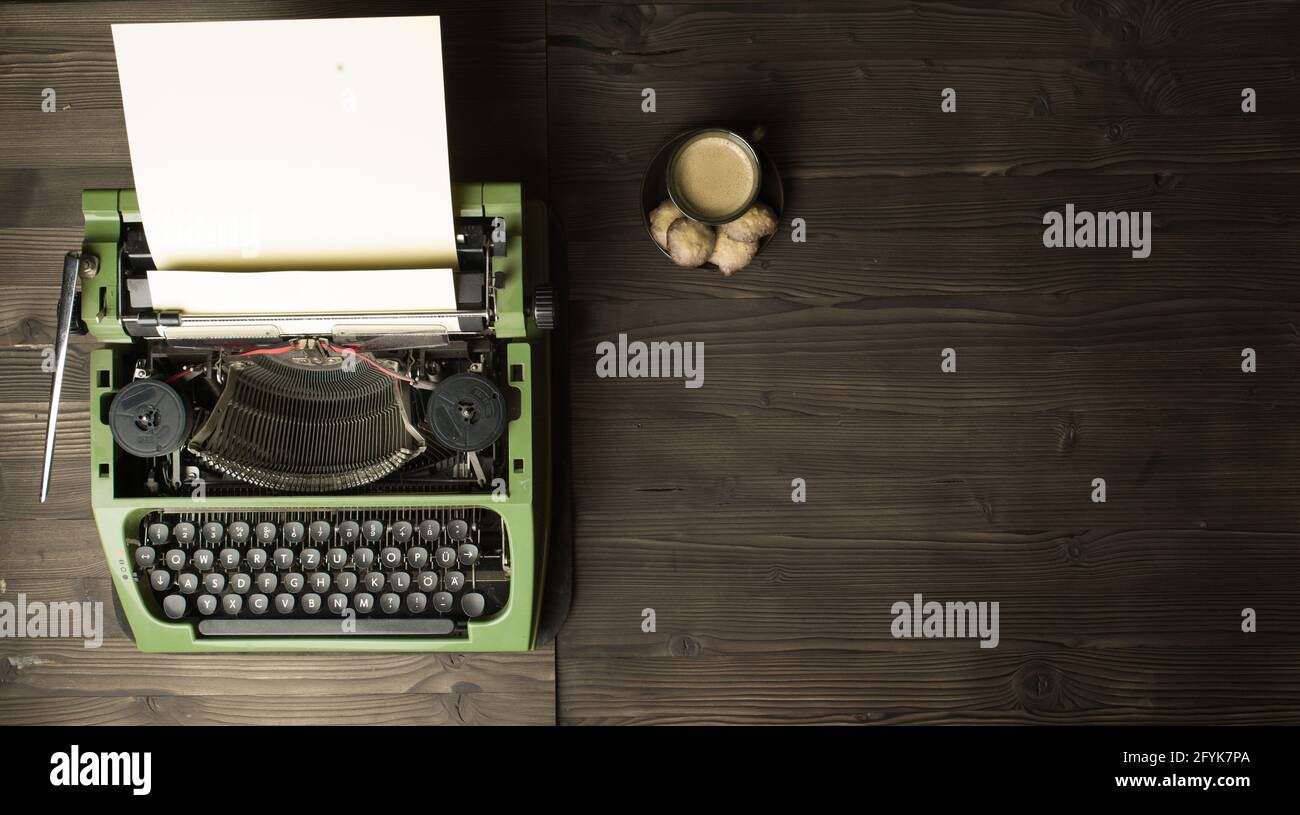 old typewriter with blank paper and coffee Stock Photo