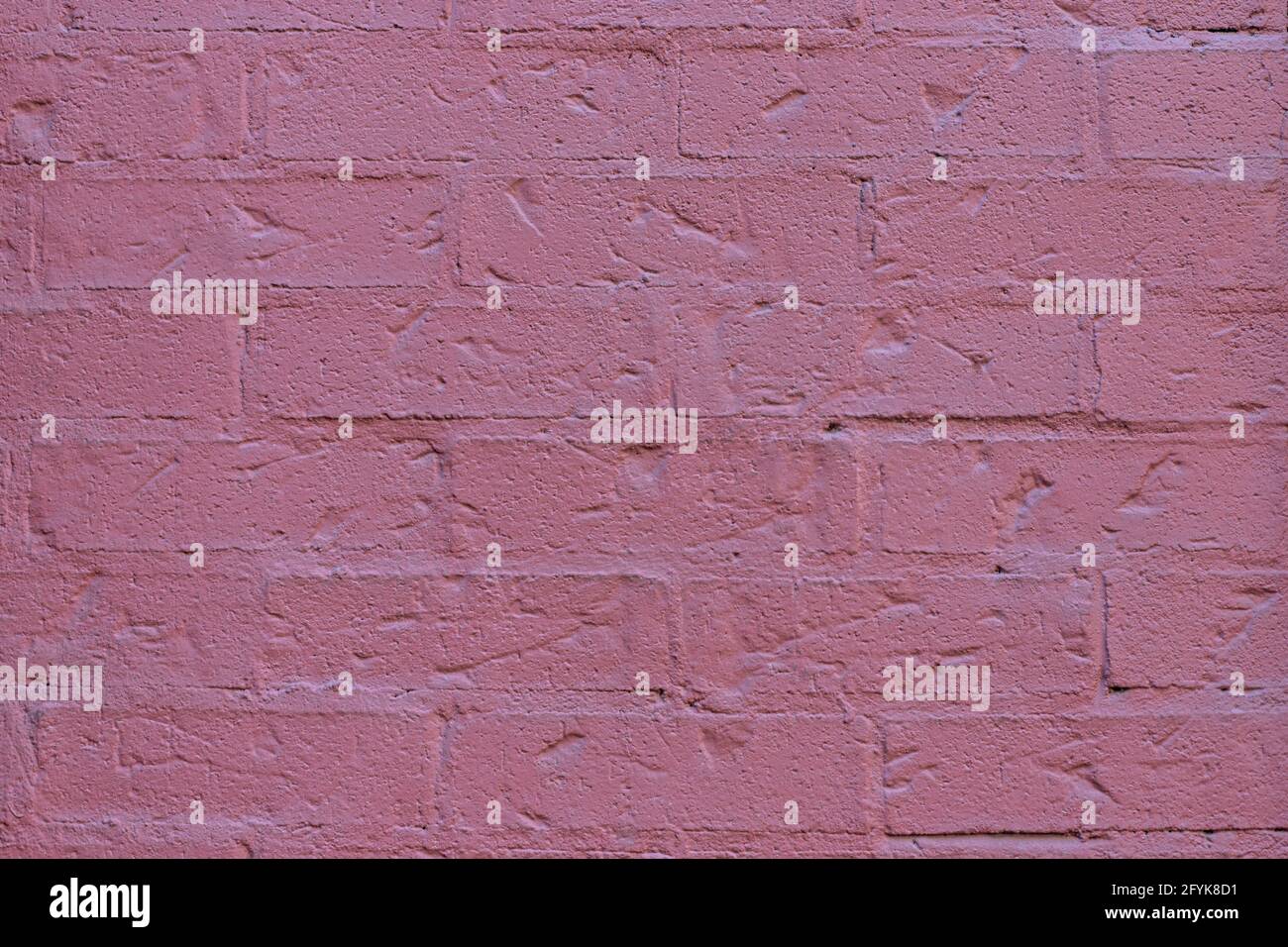 Close up of painted pink brick wall texture background. Stock Photo