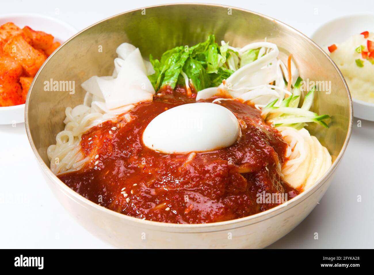 Asian noodles, salad, kimchi sauce, and a hard boiled egg at a Korean